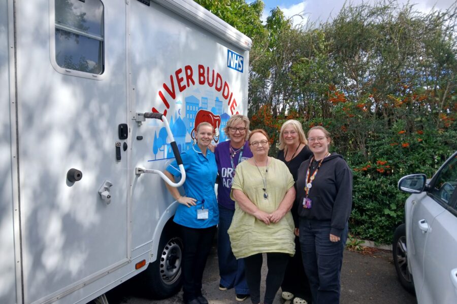 Liver Buddies Team outside mobile clinic vehicle